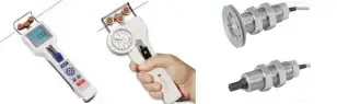 Hand holding a white handheld device with a round dial, plus two gray tool/connector components on white background