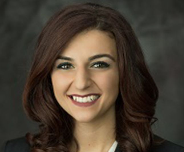 a woman with long brown hair is smiling for the camera
