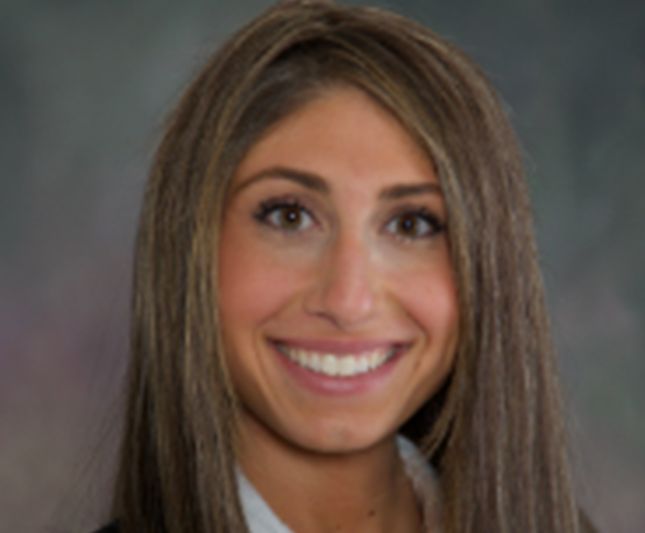 a woman with long brown hair is smiling for the camera