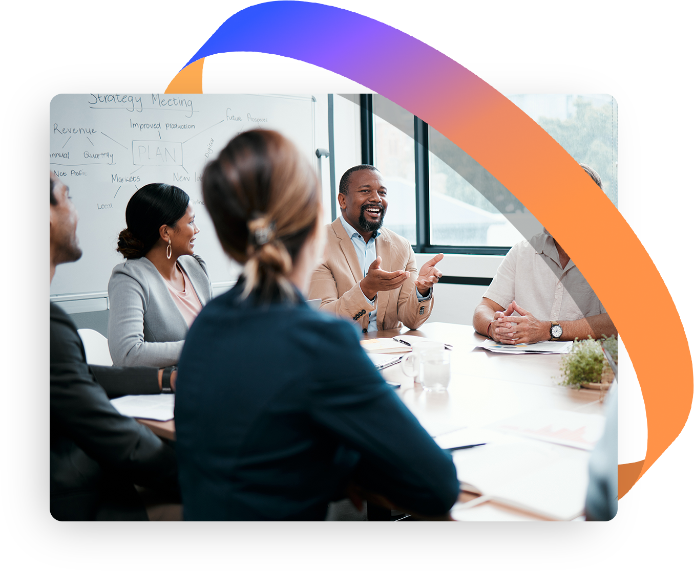People in business attire at a conference table, discussing ideas.