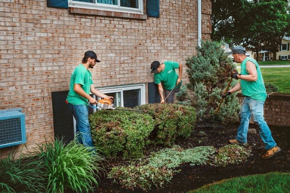 Stone patio with a waterfall feature under a porch roof; a truck is in the background.