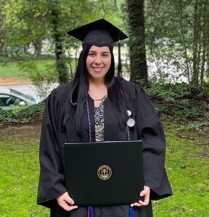 A woman is hugging a little girl on a couch.