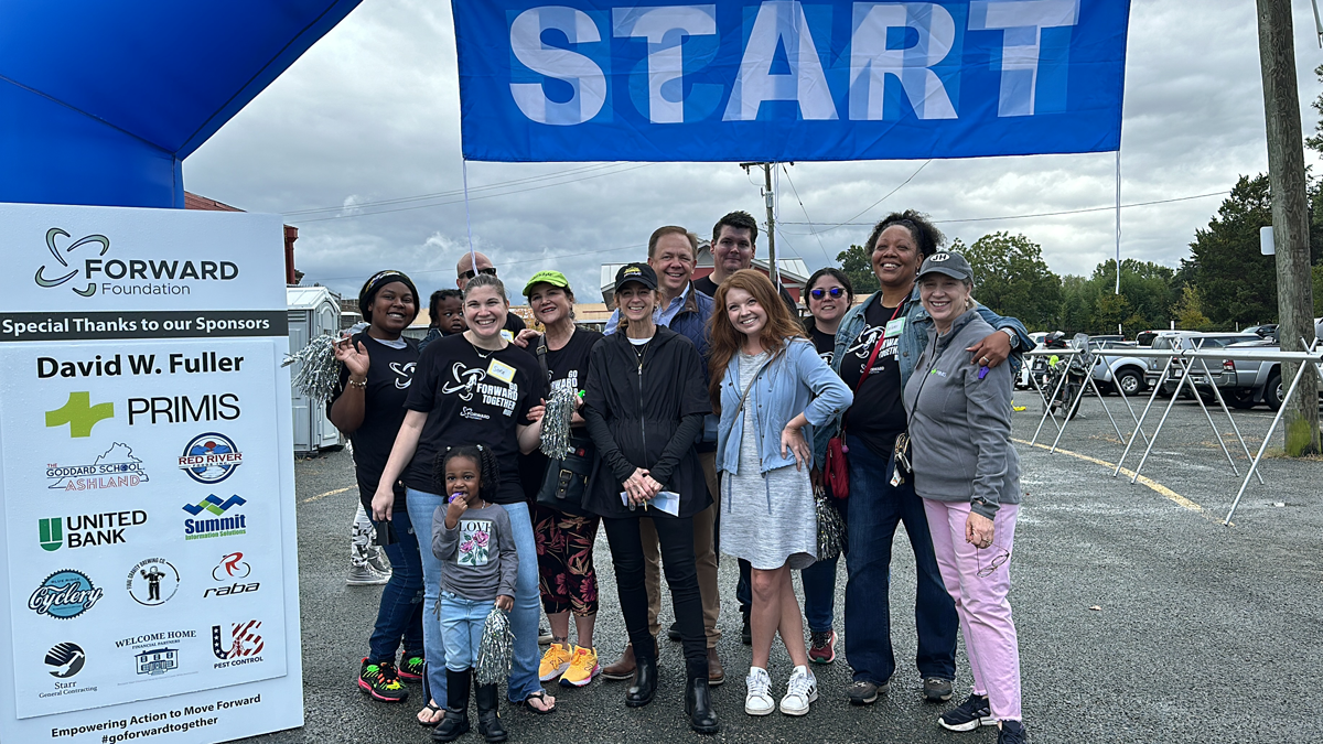 A group of women are standing next to each other holding wooden signs.