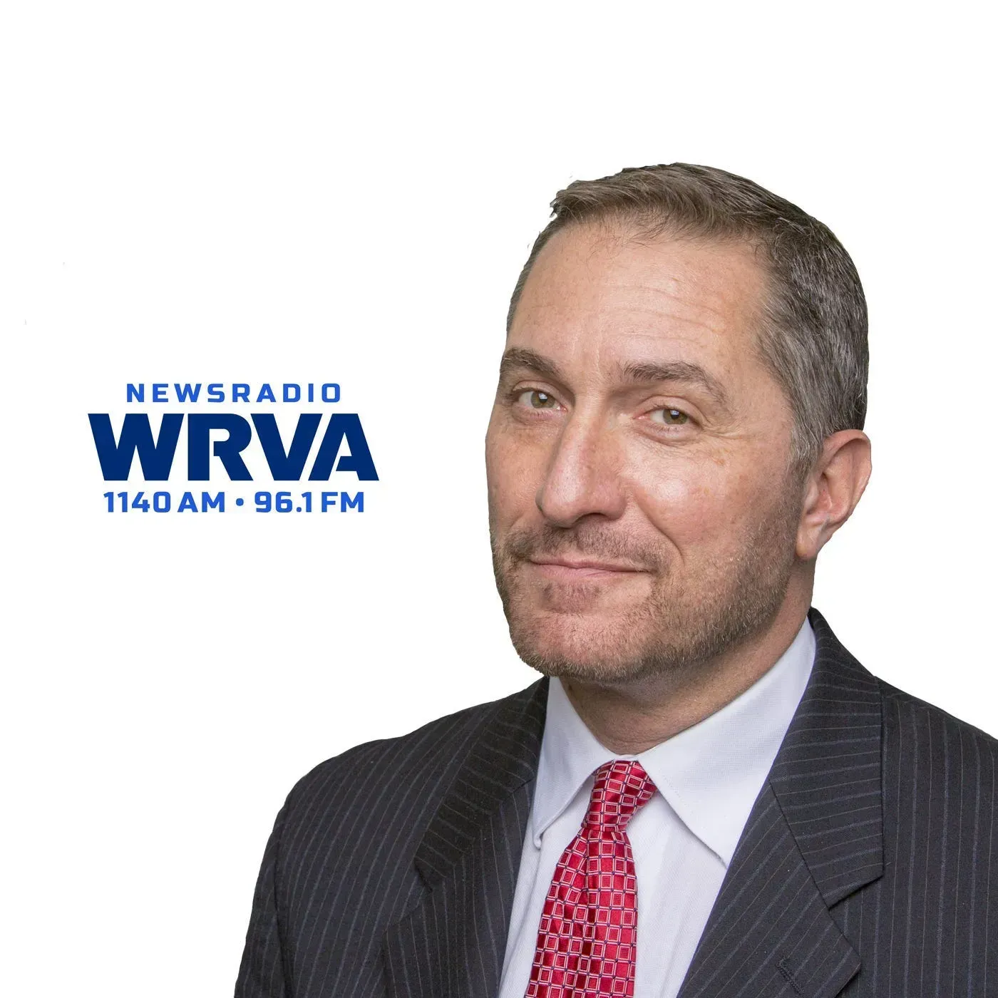 A man in a suit and tie is standing in front of a logo for newsradio wrva