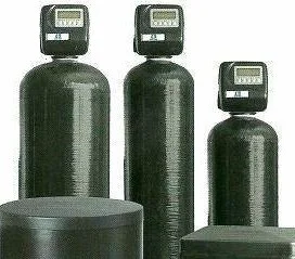 a group of black water softeners are sitting next to each other on a white background .