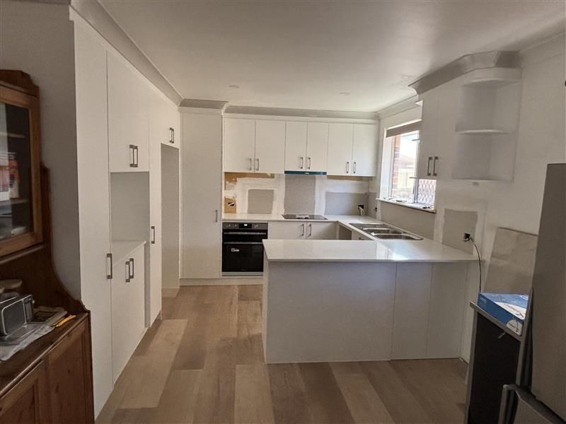 Modern Kitchen With Sleek White Cabinets — Piscopo Kitchens Plus In Forster, NSW