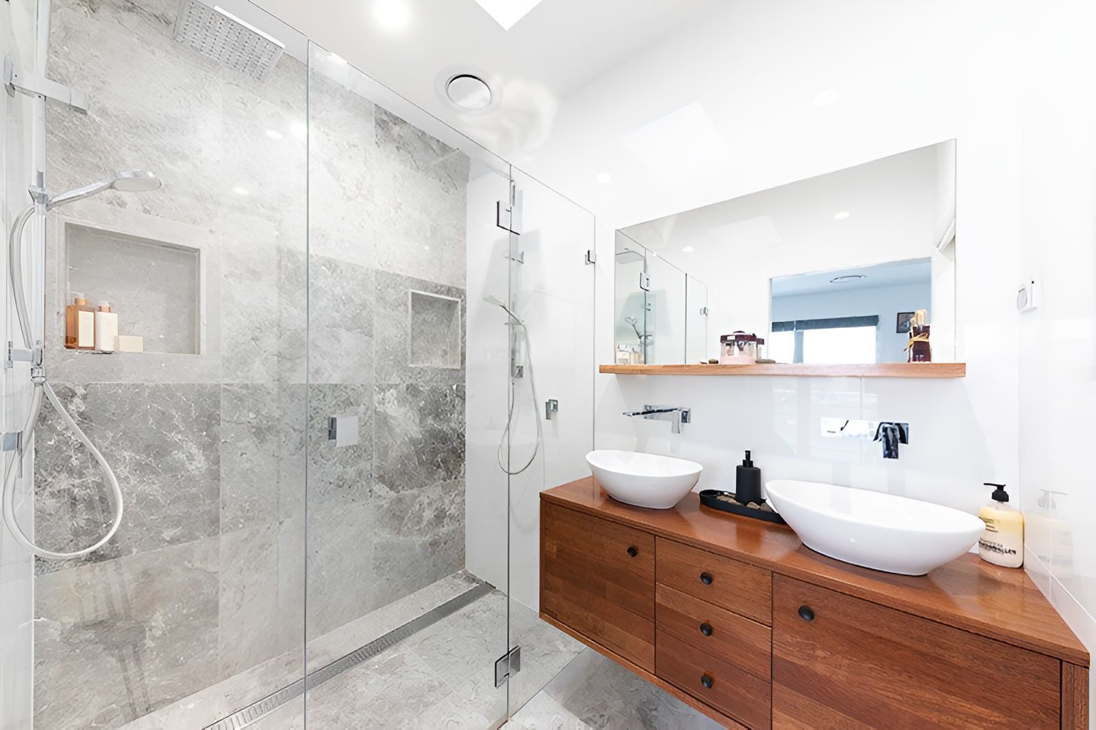 Bathroom With a Glass-enclosed Shower Featuring Stone Tiles — Piscopo Kitchens Plus In Smiths Lake, NSW