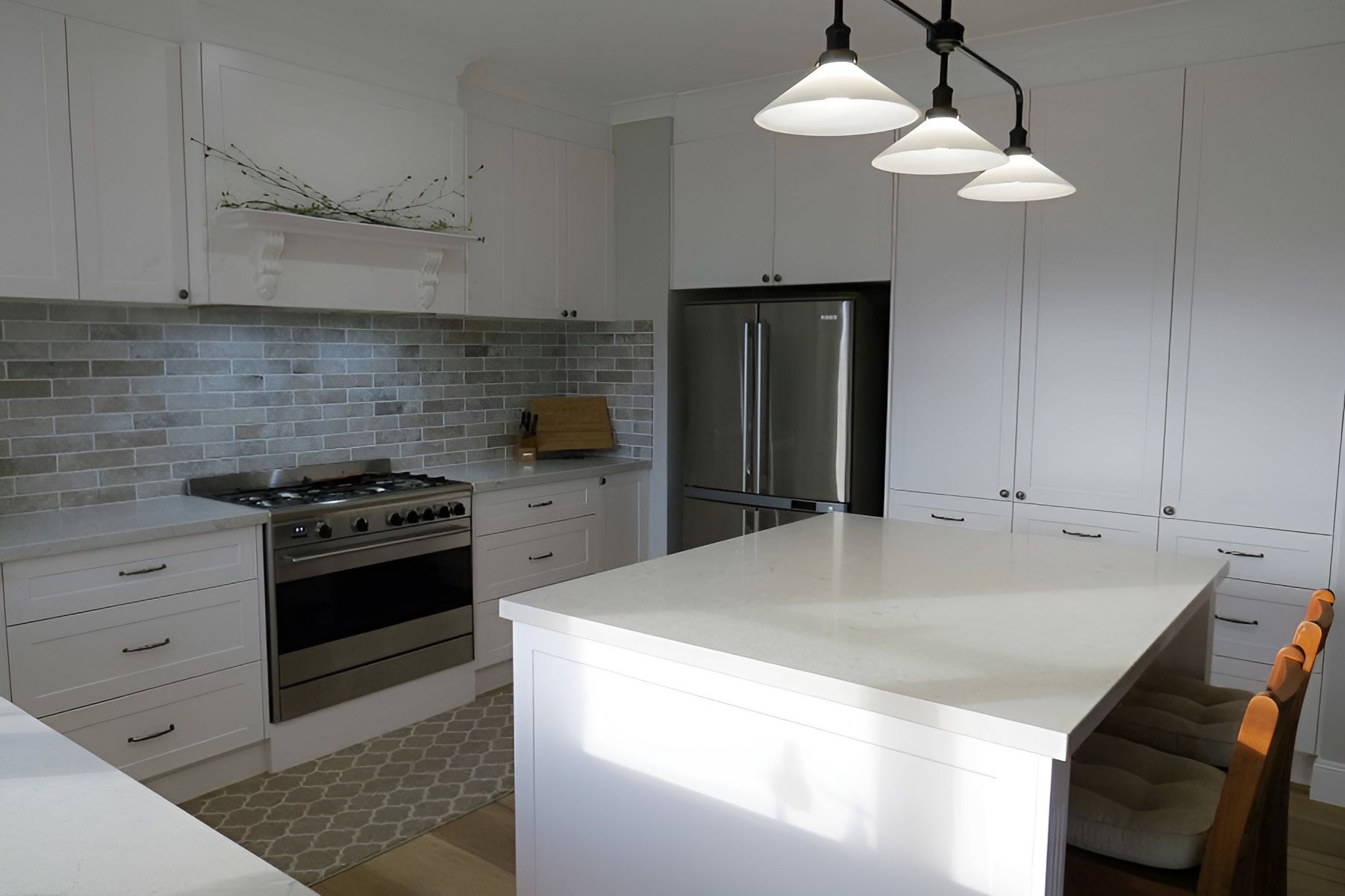 Kitchen With a Large Island and Pendant Lights— Piscopo Kitchens Plus In Forster, NSW