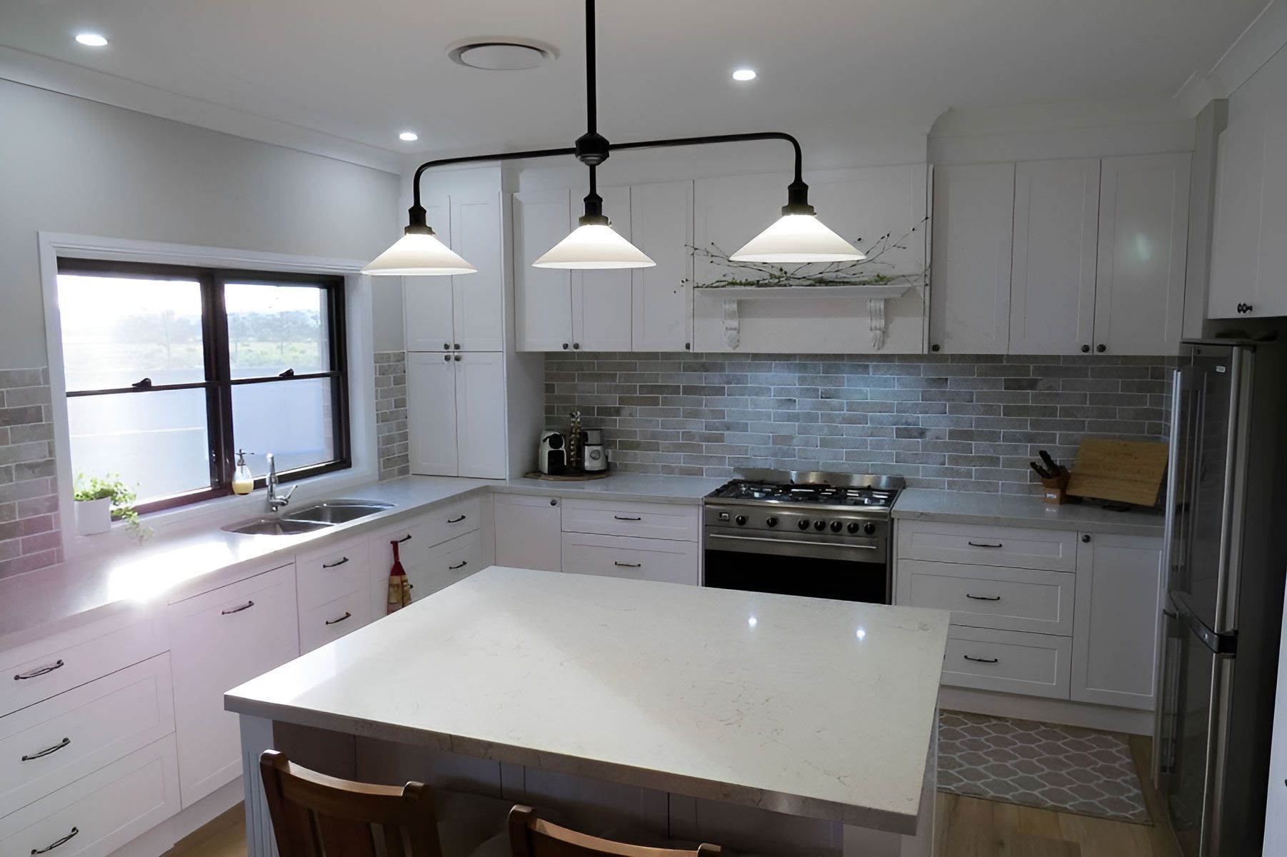Modern Kitchen With Cabinets and a Central Island — Piscopo Kitchens Plus In Forster, NSW