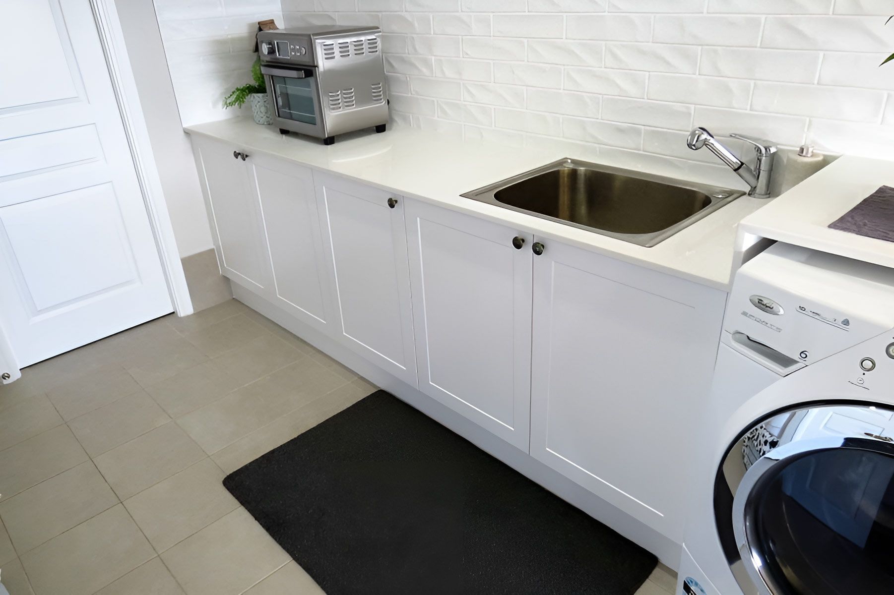 Laundry Room With a Partially Visible Washing Machine — Piscopo Kitchens Plus In Hallidays Point, NSW