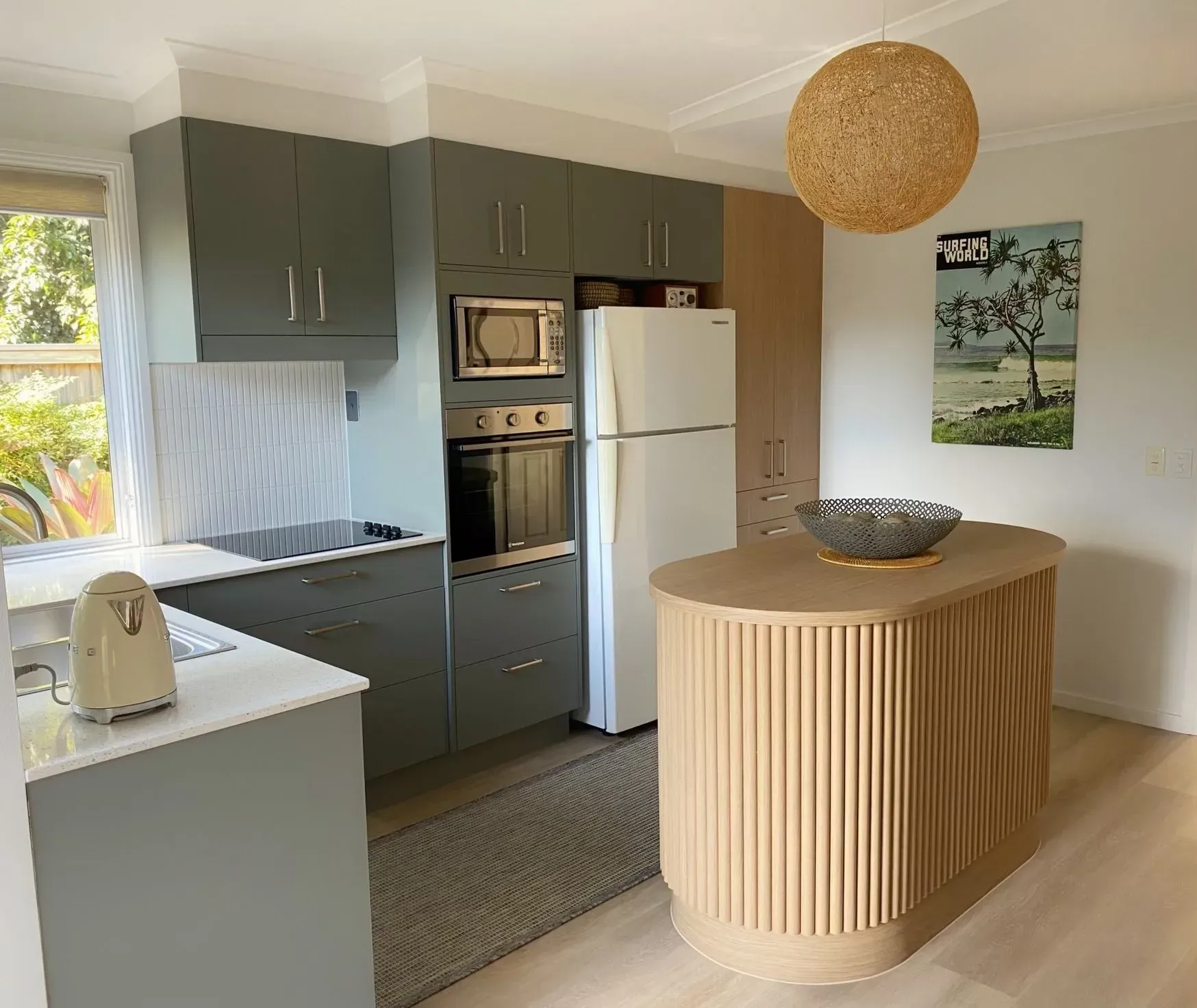 Kitchen with gray cabinets, wooden island, white appliances, and woven light fixture. — Piscopo Kitchens Plus In Forster, NSW