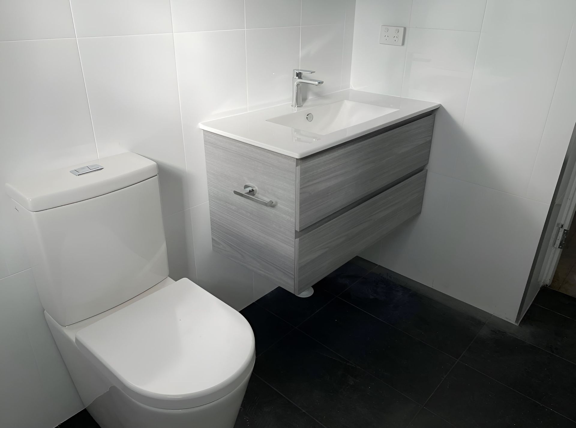 A Bathroom With a Toilet, Sink and Vanity — Piscopo Kitchens Plus In Forster, NSW