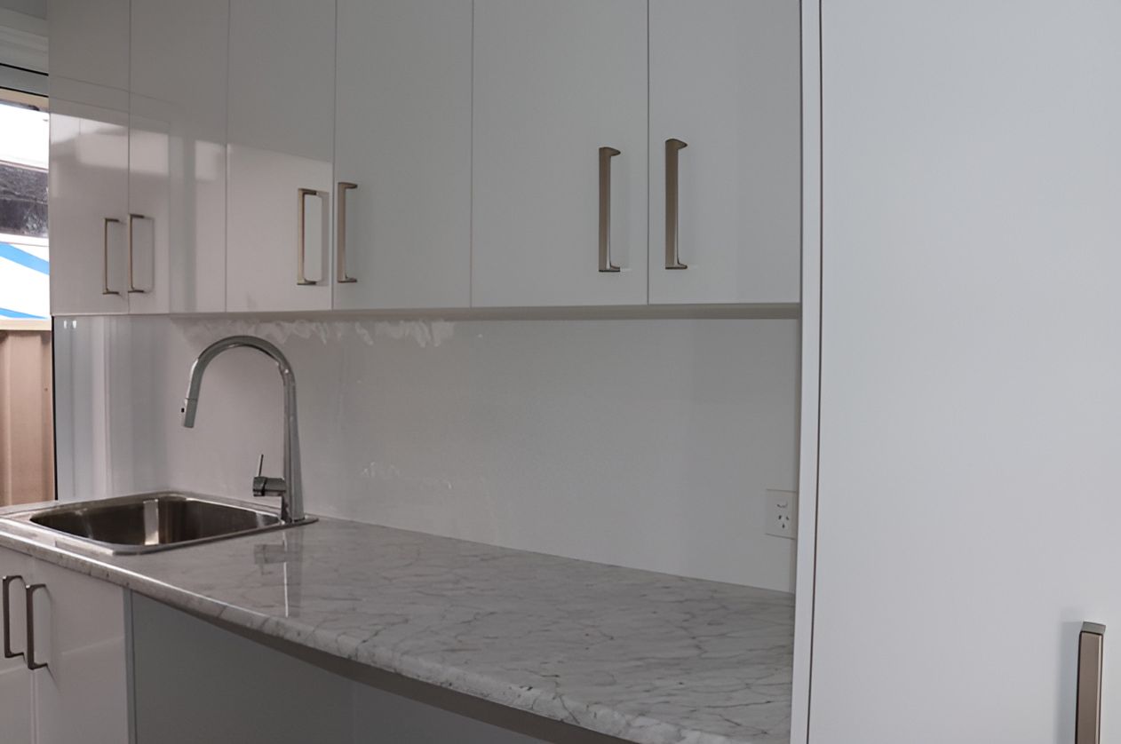 Modern Kitchen With Glossy White Cabinets — Piscopo Kitchens Plus In Forster, NSW