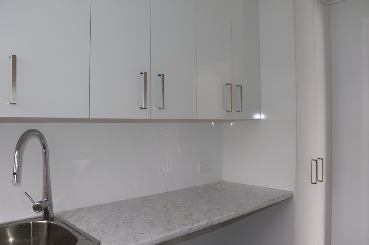 A Shiny Stainless Steel Faucet is Over a Sink — Piscopo Kitchens Plus In Forster, NSW