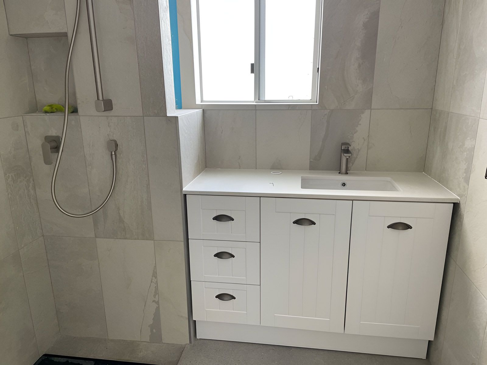 Bathroom With White Cabinetry and Silver Handles — Piscopo Kitchens Plus In Forster, NSW