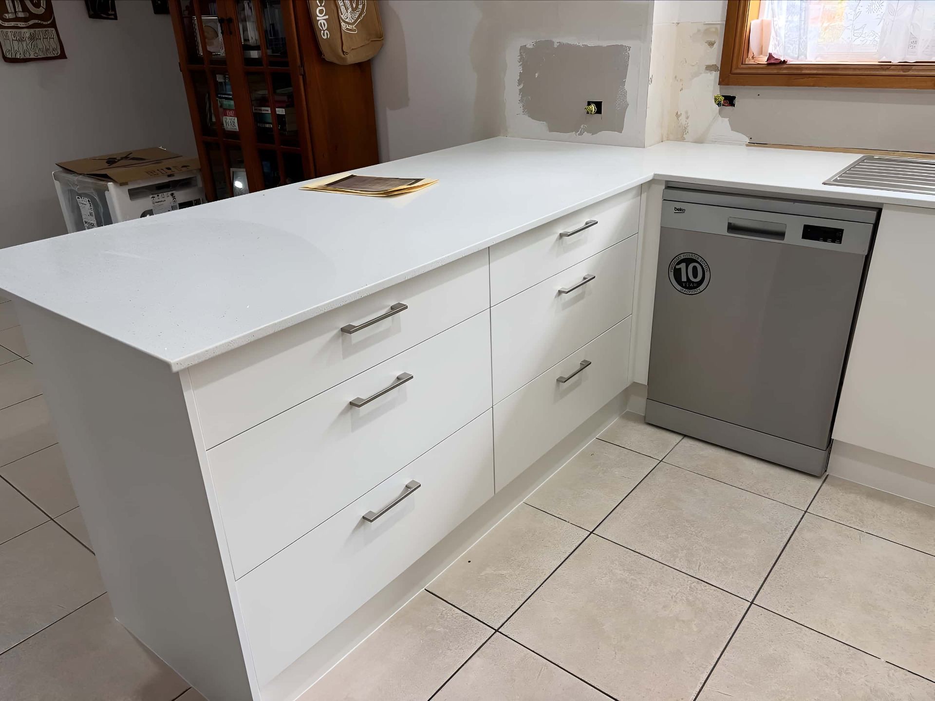 Modern Kitchen With White Cabinets and Silver Handles — Piscopo Kitchens Plus In Forster, NSW