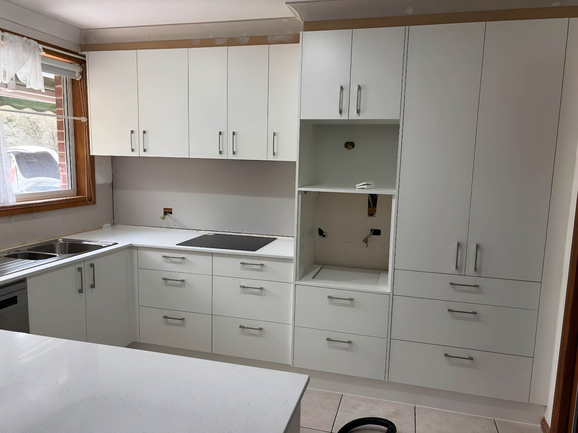 Modern Kitchen With White Cabinets and Drawers — Piscopo Kitchens Plus In Forster, NSW