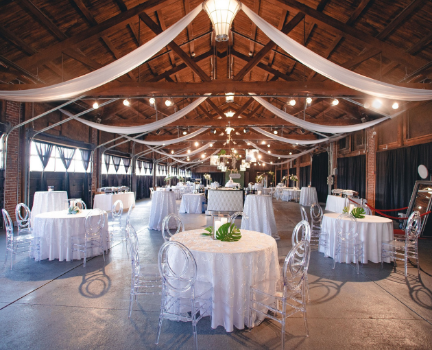 wedding reception tables with clear chairs