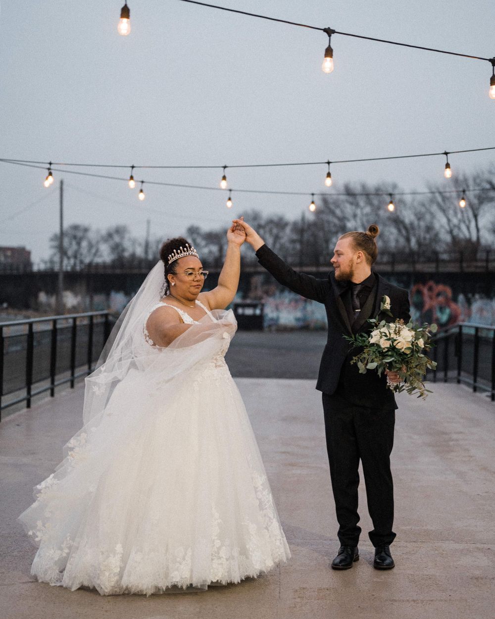 groom twirling bride