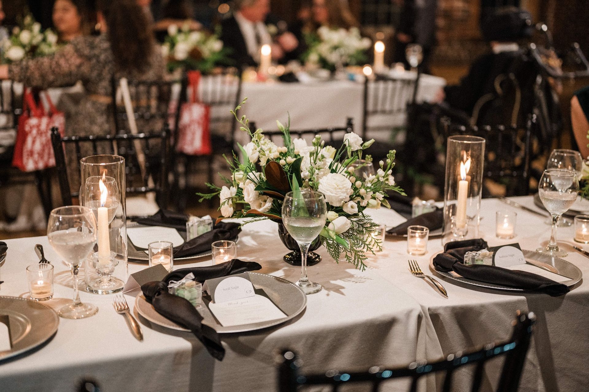 black, white, and silver wedding reception place settings