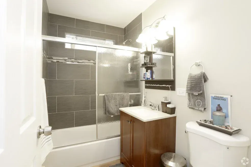 A bathroom with a sink , toilet , bathtub and shower.