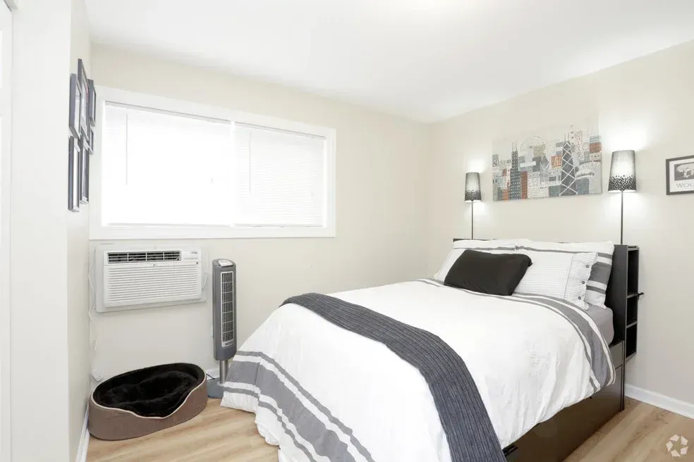 A bedroom with a bed and a dog bed