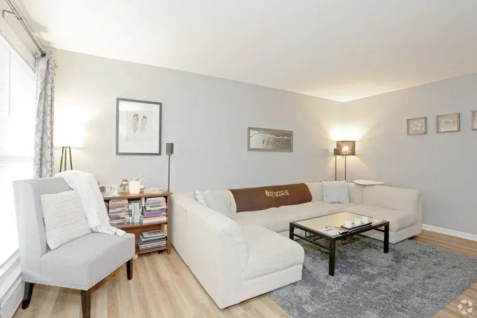 A living room with a couch , chair and coffee table