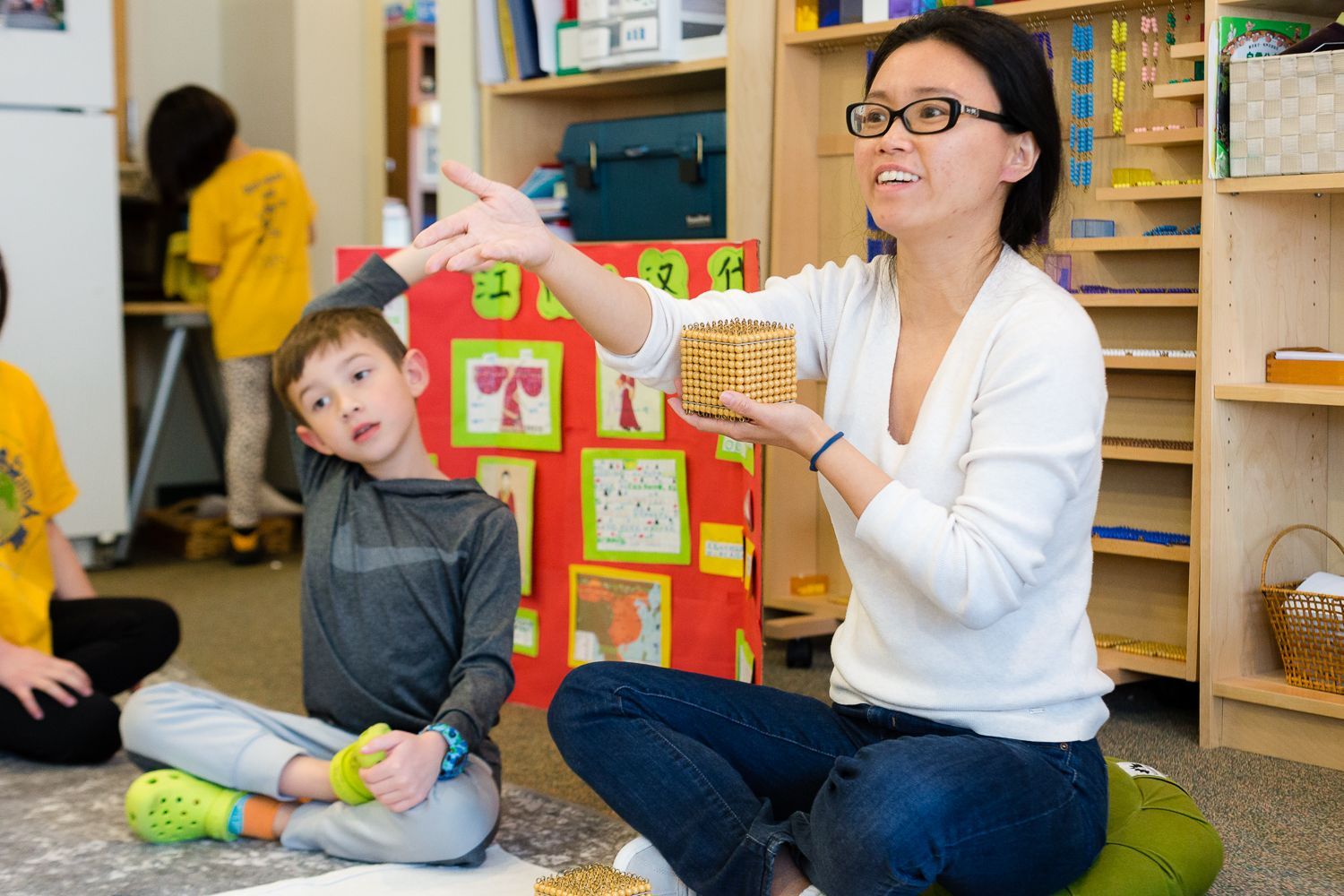 Children and guide in a Montessori classroom