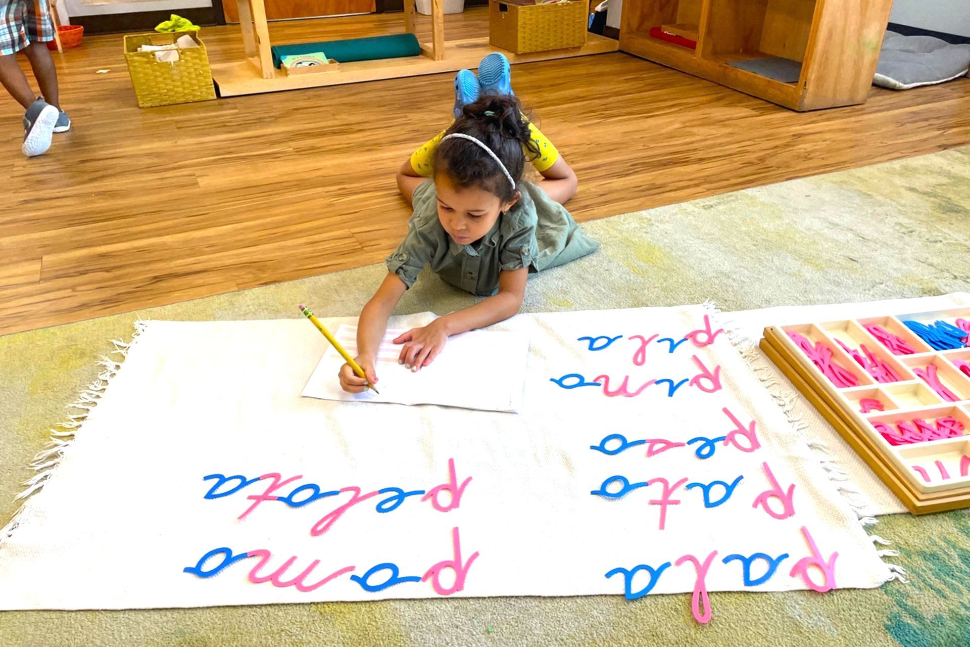 Montessori child working on writing skills