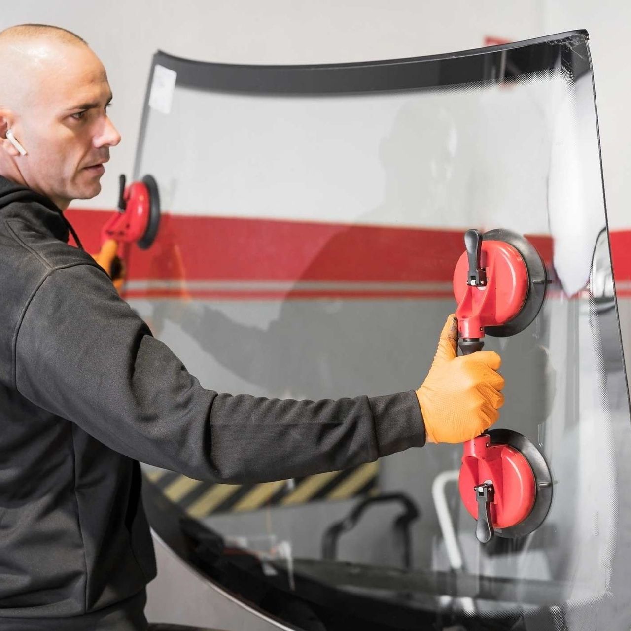 Man carrying windshield with two suction cups — San Antonio, TX — Rockguard Autoglass