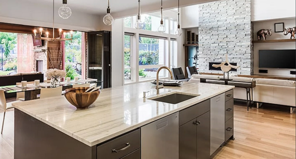 There is a large island in the middle of the kitchen.