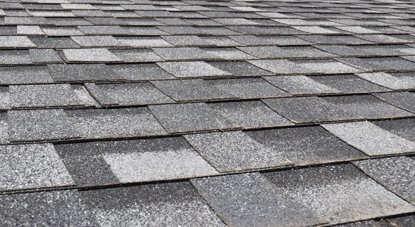 A close up of a roof with a lot of shingles on it.