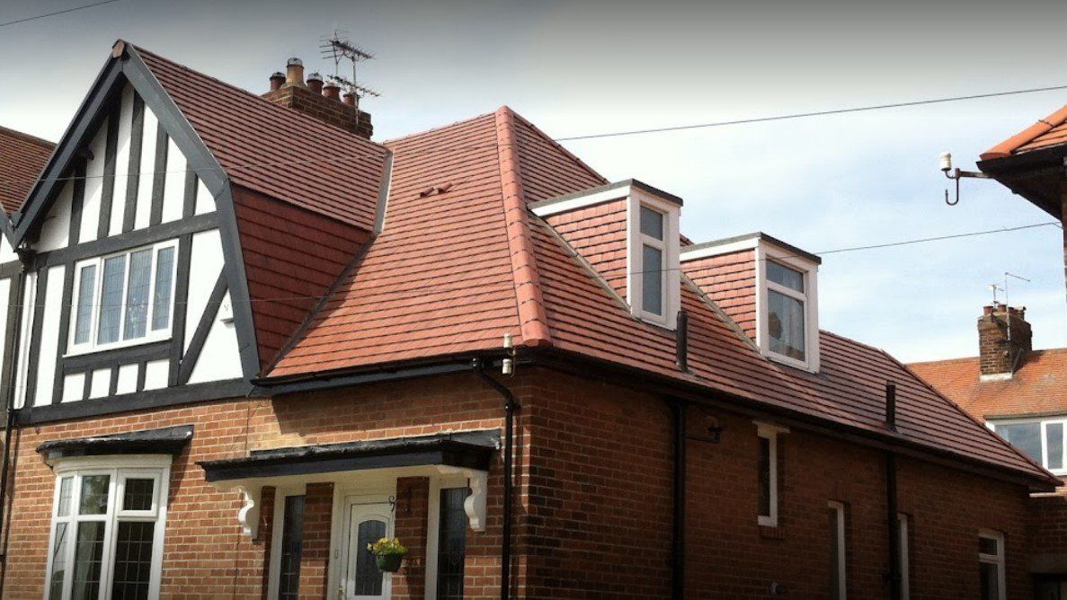 A picture of a dormer roof replacement in red clay tile by Roofers Birmingham