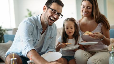 Happy Family Sharing Pizza at Home — Stroudsburg, PA — New Horizons Transportation LLC