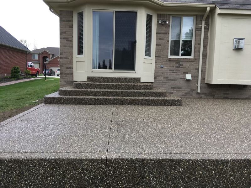A house with a concrete patio in front of it
