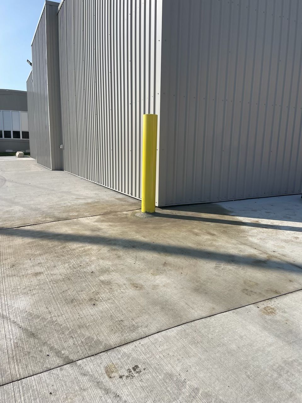 A building with a yellow pole in front of it