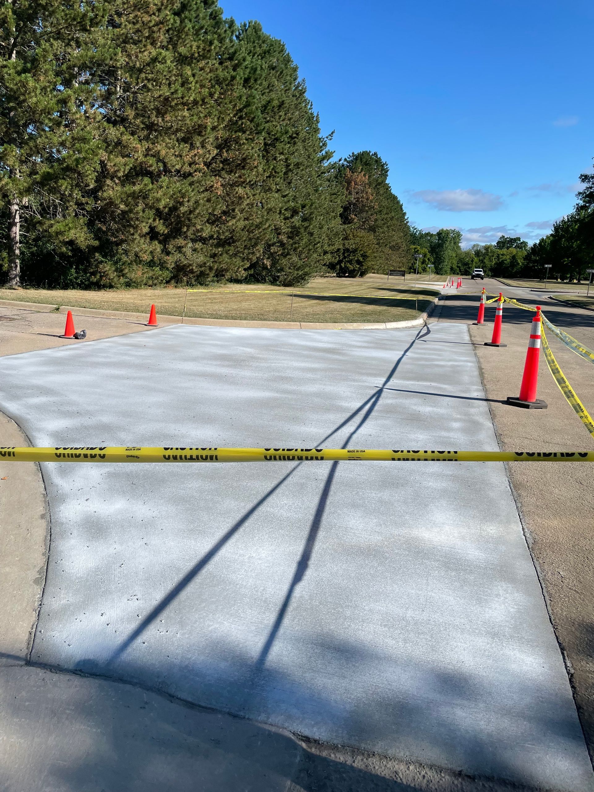A concrete walkway is being built next to a road.