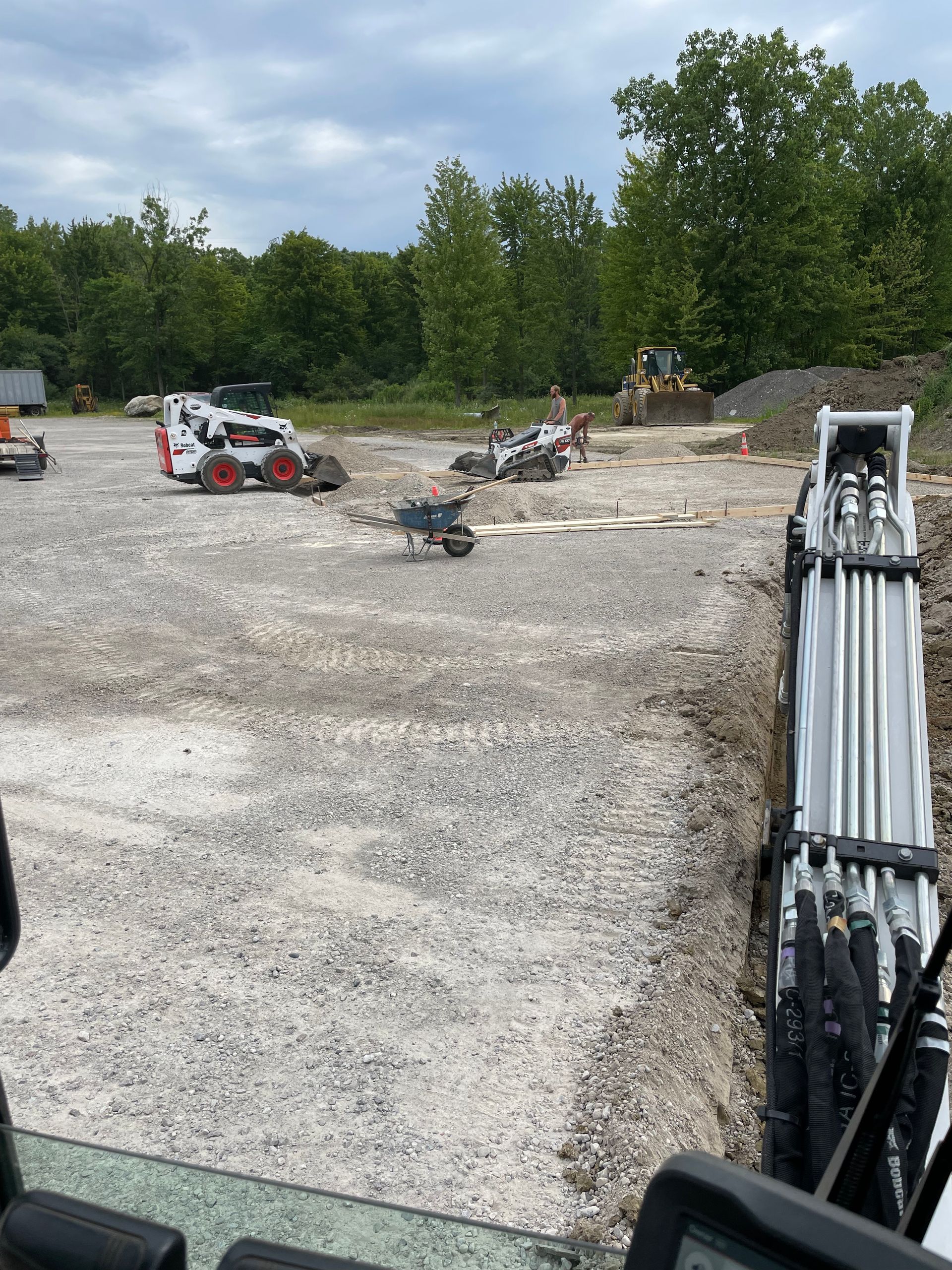 A bulldozer is digging a hole in a dirt field.