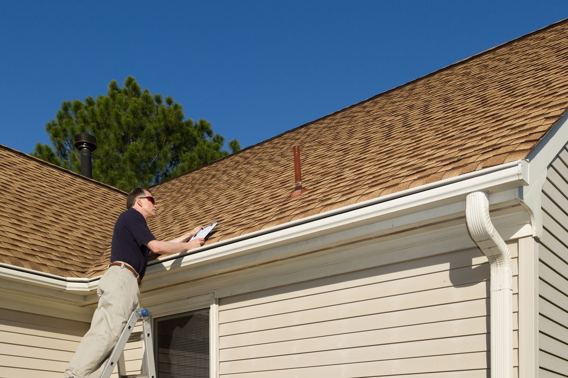 A skilled roofer from United Roofing examines a roof during a residential roof maintenance service in Marlton, NJ.