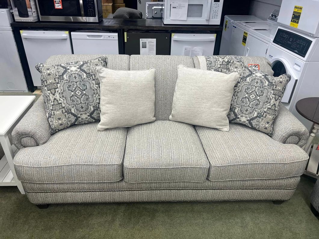 grey couch with decorative pillows