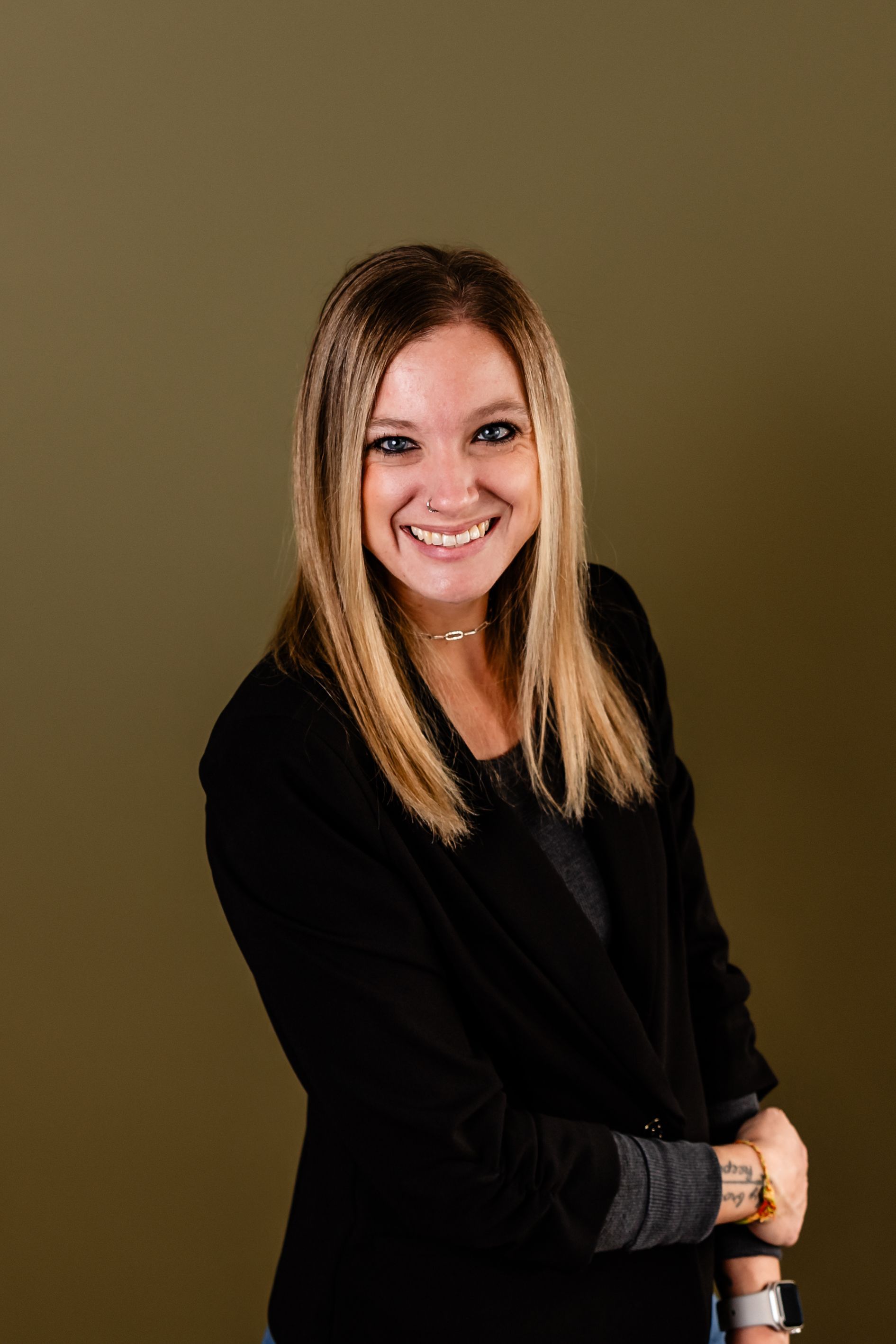Agent Amanda Ferguson is wearing a black jacket and smiling for the camera.