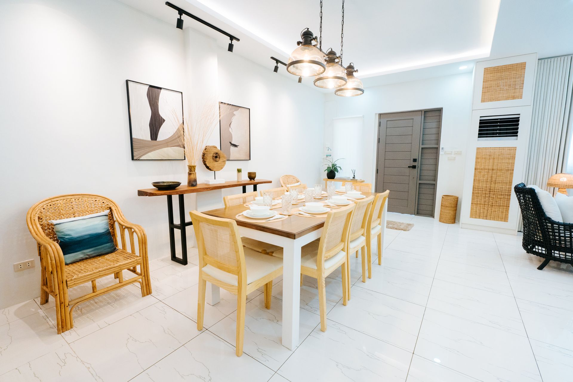 A bright dining room with a long wooden table, chairs, and decorative elements.