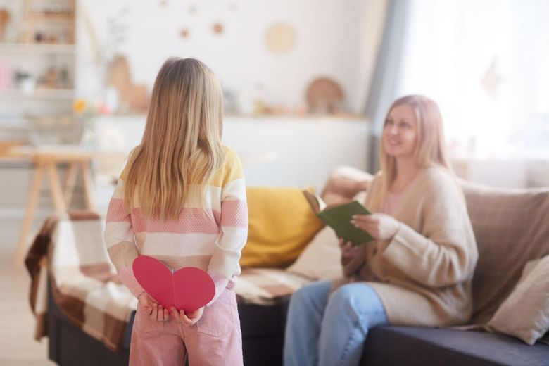 Child surprising parent with heart gift during autism family support session
