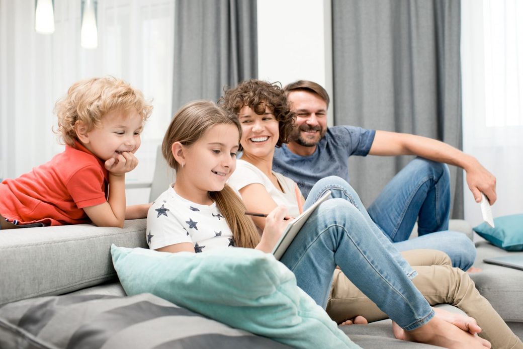 Happy family bonding together at home after autism therapy support