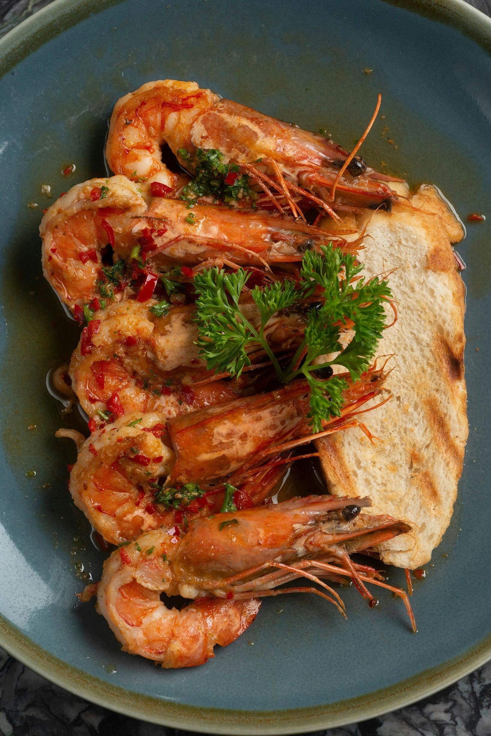 A close up of a plate of food with meat and vegetables on a table.