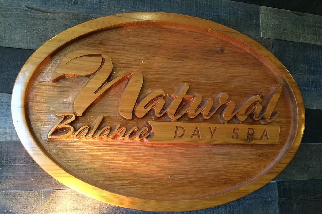 Wooden oval sign carved with the words