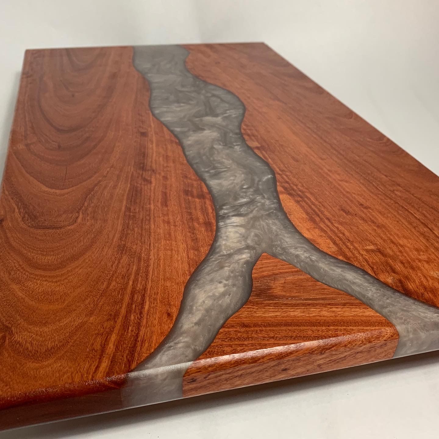 A wooden cutting board with a river in the middle of it.