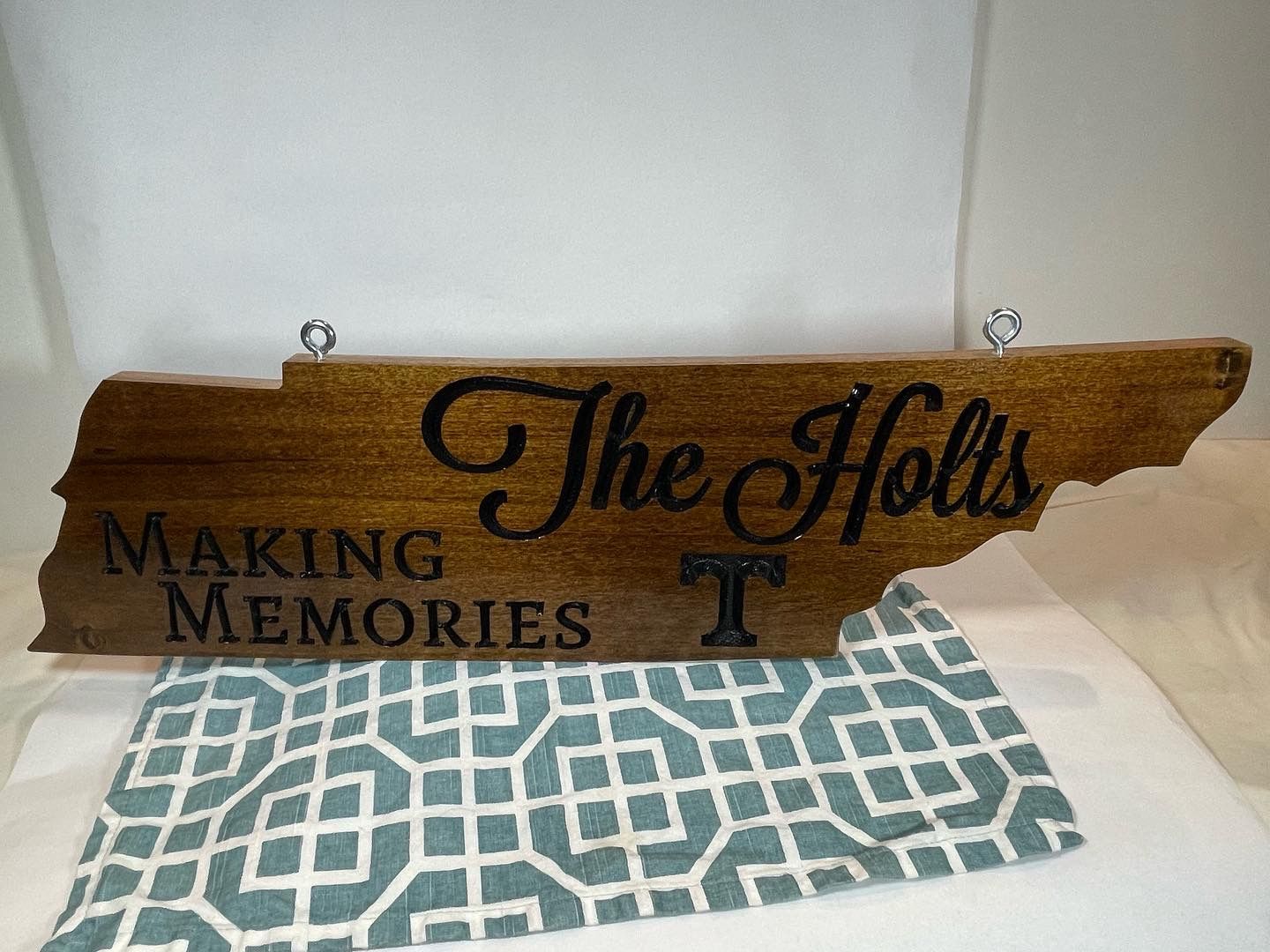 A wooden sign that says `` the holts making memories '' is sitting on a table.