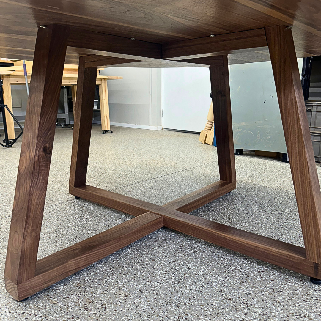 A wooden table is sitting on a carpeted floor in a room.