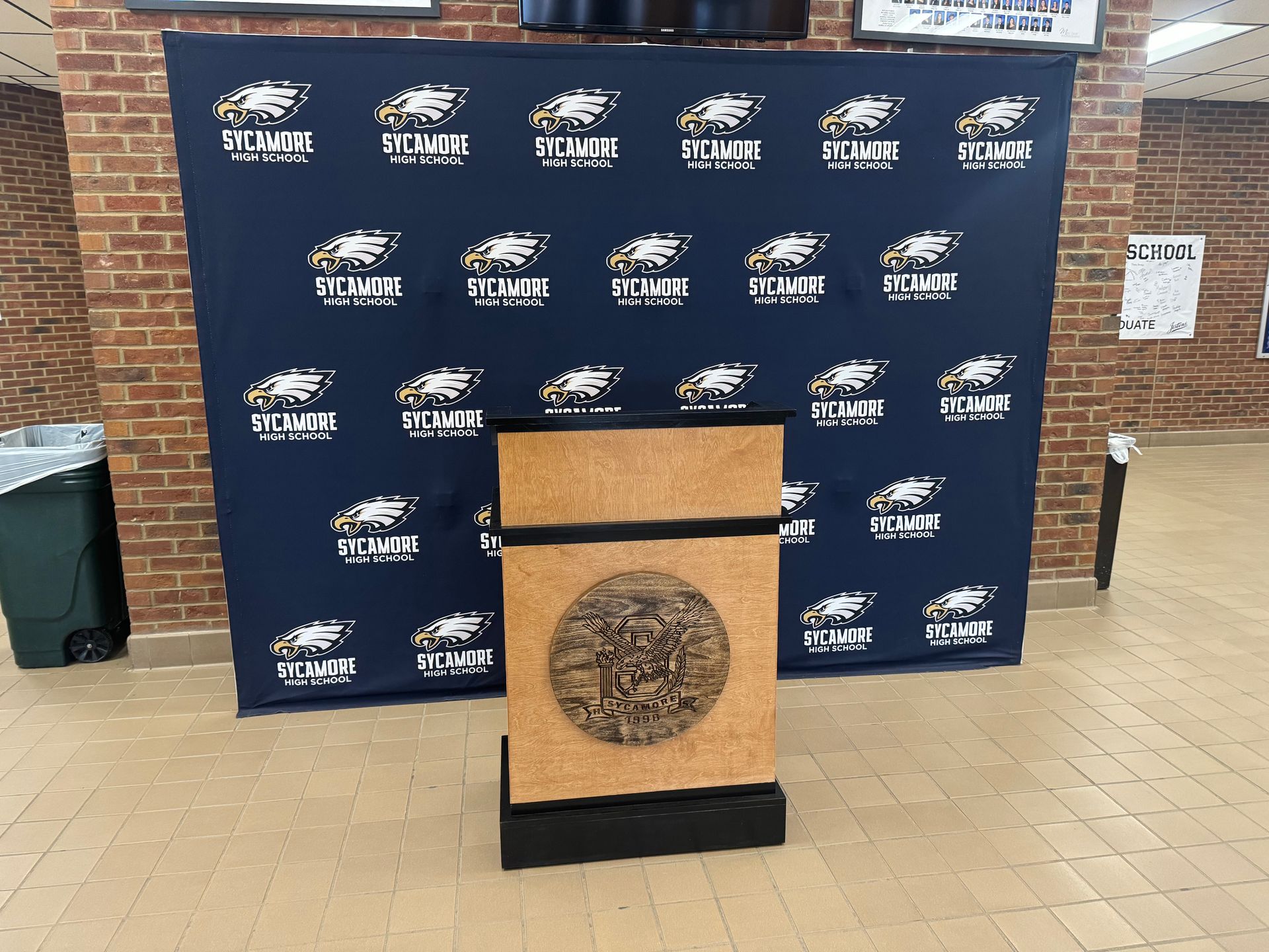 A podium in front of a wall that says ' stadium ' on it
